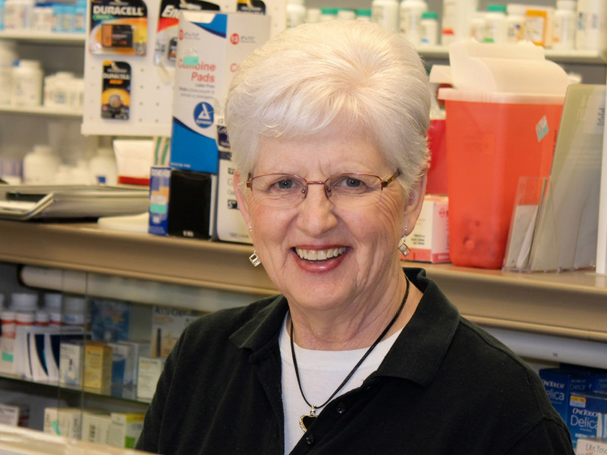 Smiling Lititz Apothecary team member at the pharmacy counter in Lititz, PA