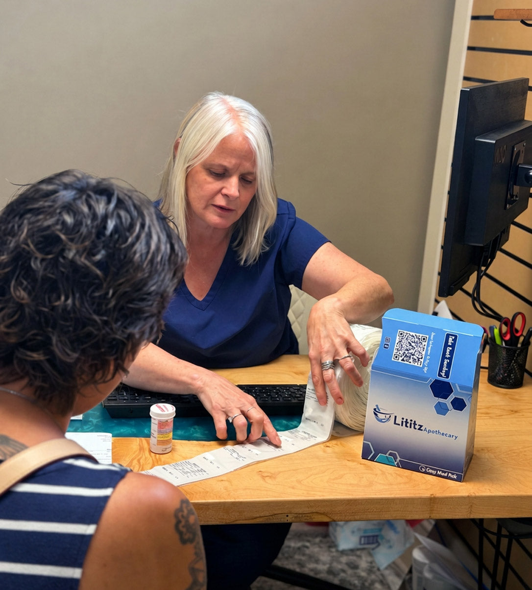 Lititz Apothecary pharmacist reviewing medications with a patient at the consultation desk
